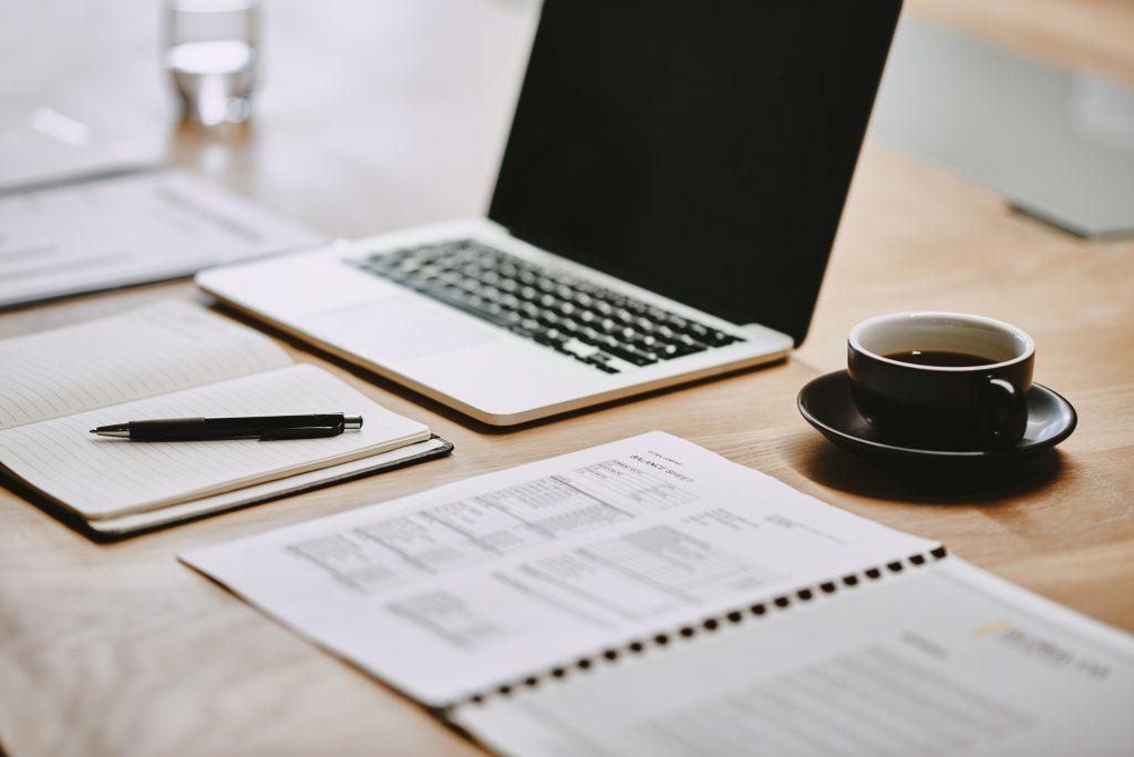 Shot of a notebook and laptop in an office